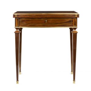 A French Empire mahogany combination table, finely inlaid with brass