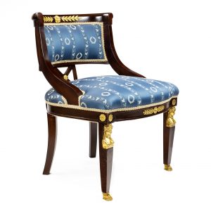 A French Empire style chair in mahogany with omalu mounts and masks